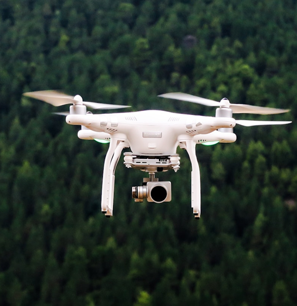 Drone in flight over forest